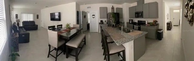 a view of a living room with furniture and flat screen tv