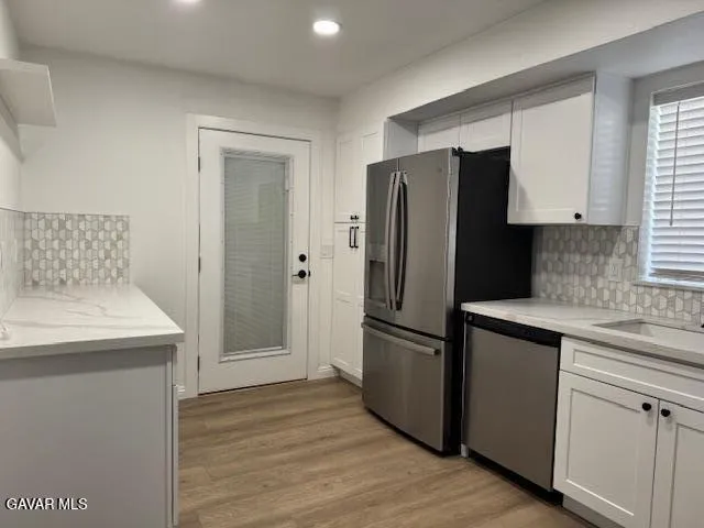 a kitchen with white cabinets and a sink