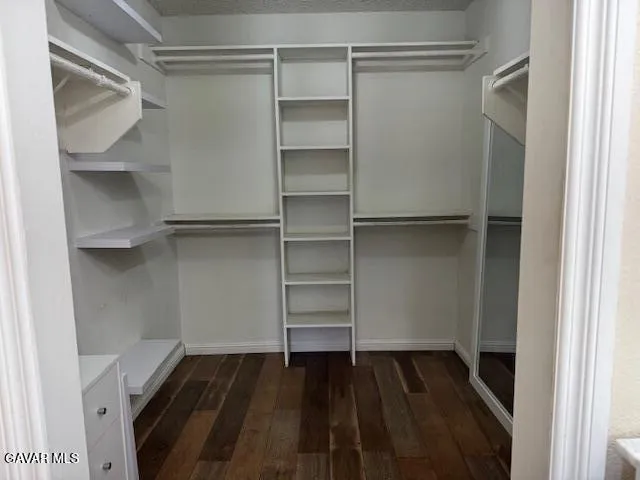 a bathroom with a granite countertop toilet sink and a mirror