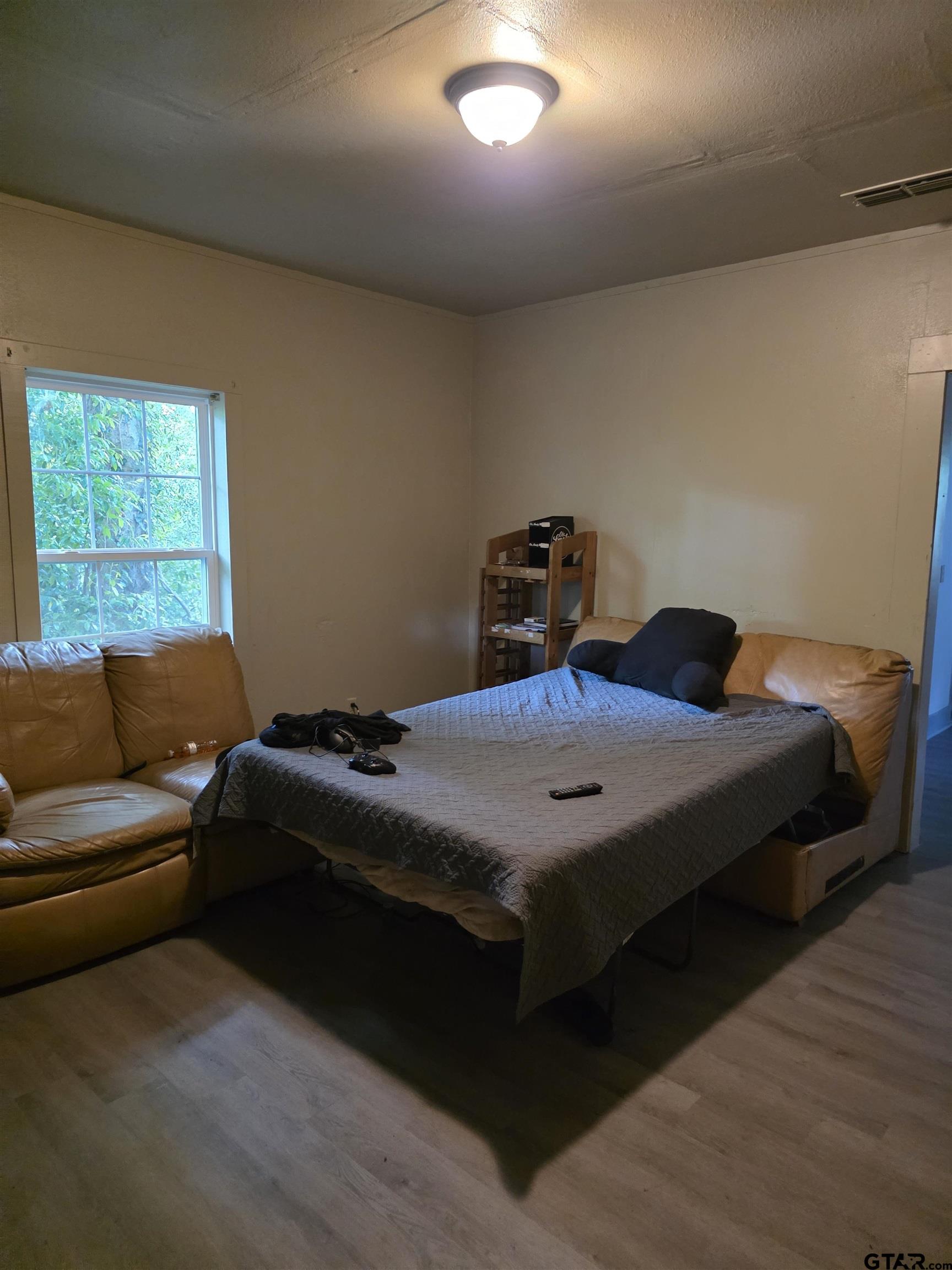 316 North Hospital Street Rusk, TX 75785 - Photo 9 of 21 a bedroom with a bed and a large window