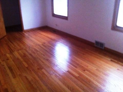 688 Milton Road Inverness, IL 60067 - Photo 8 of 13 an empty room with wooden floor and windows