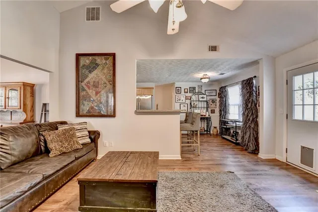 a living room with furniture and a wooden floor