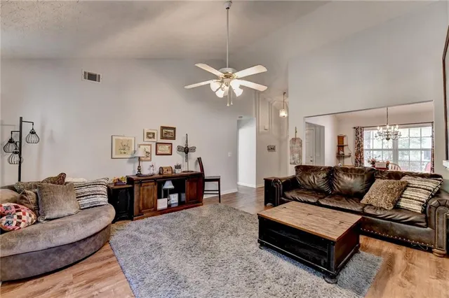a living room with furniture ceiling fan and a window