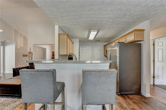 a kitchen with stainless steel appliances granite countertop a refrigerator and a stove