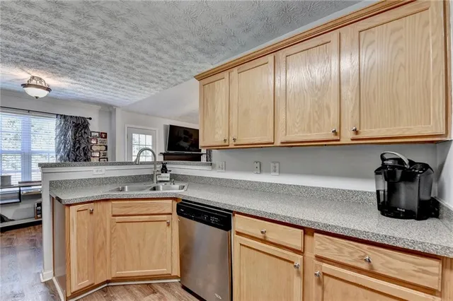 a kitchen with stainless steel appliances granite countertop a sink and cabinets