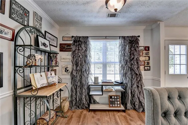 a view of front door with furniture and a window