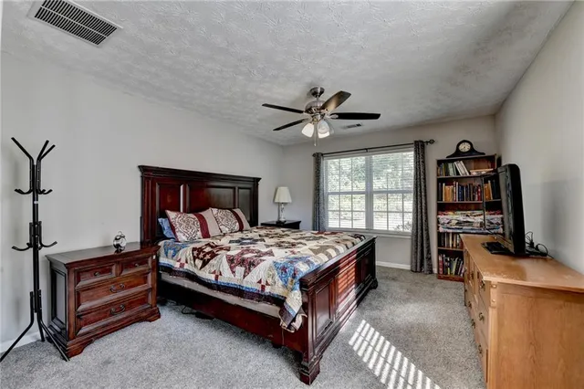 a bedroom with a bed and a tv