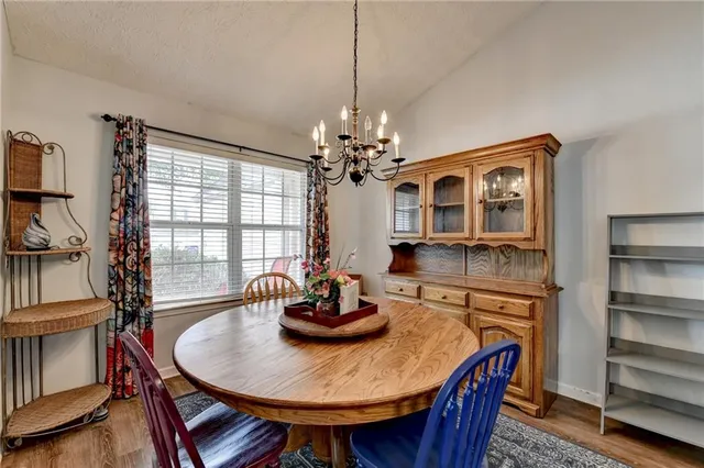 a dining room with furniture a chandelier and window