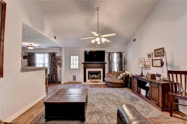 a living room with fireplace furniture and a flat screen tv