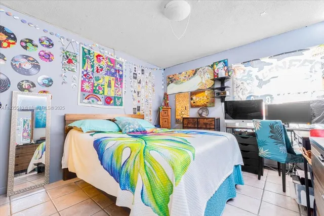 a bedroom with bed and wooden floor