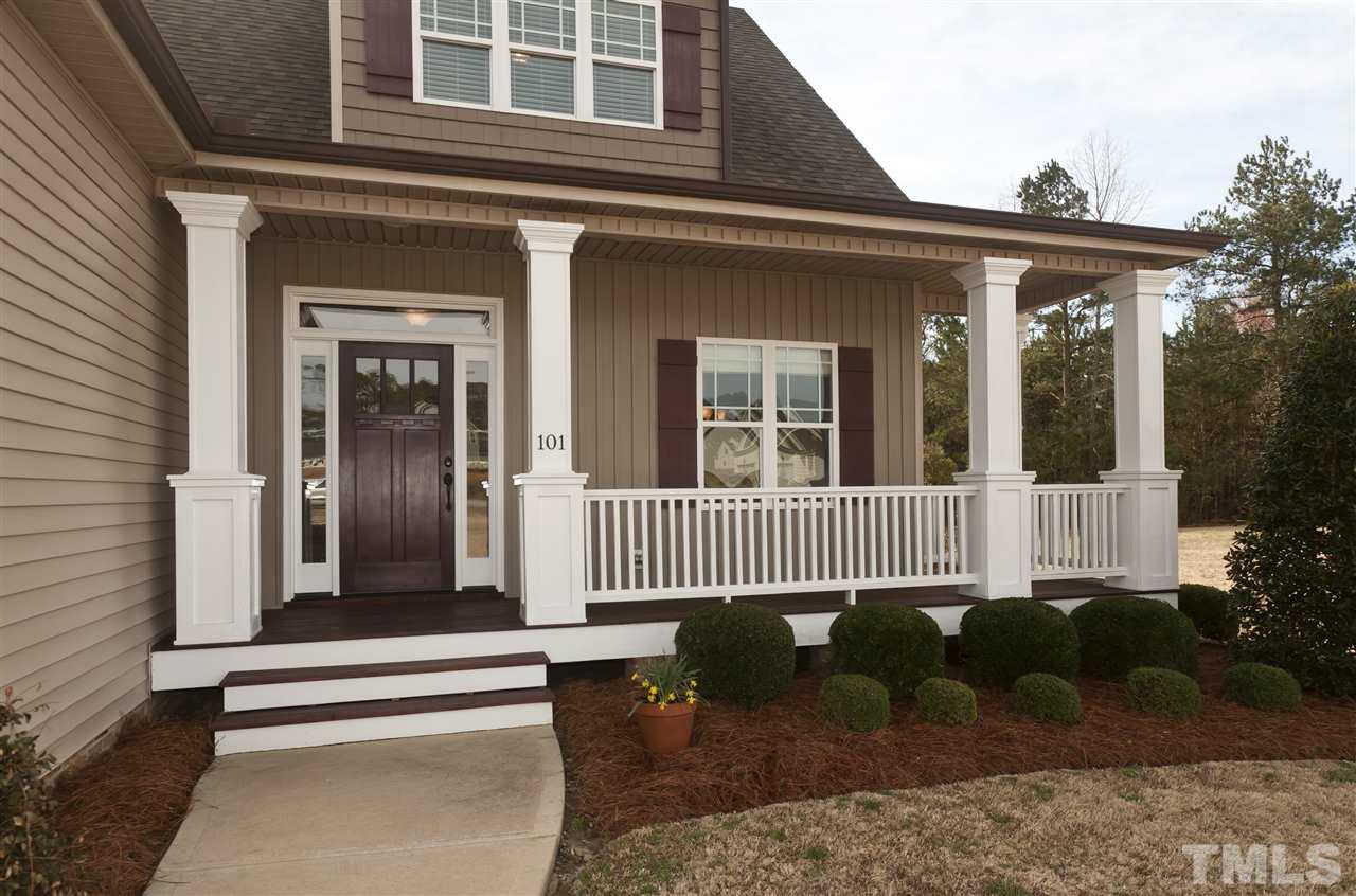 101 South Sunset Ridge Drive Willow Spring, NC 27592 - Photo 2 of 25 a front view of a house with a garden