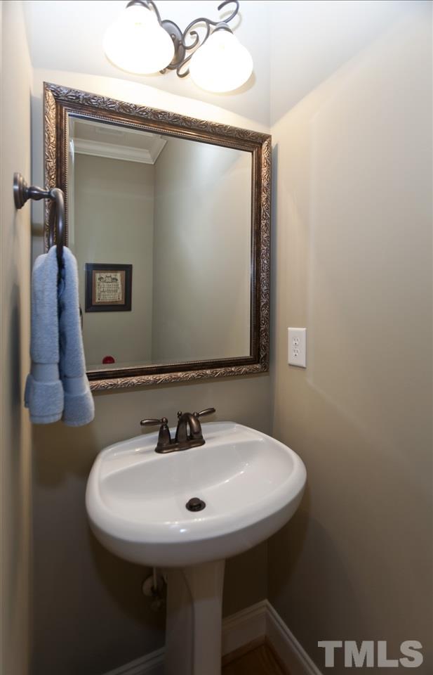 101 South Sunset Ridge Drive Willow Spring, NC 27592 - Photo 11 of 25 a bathroom with a sink and a mirror