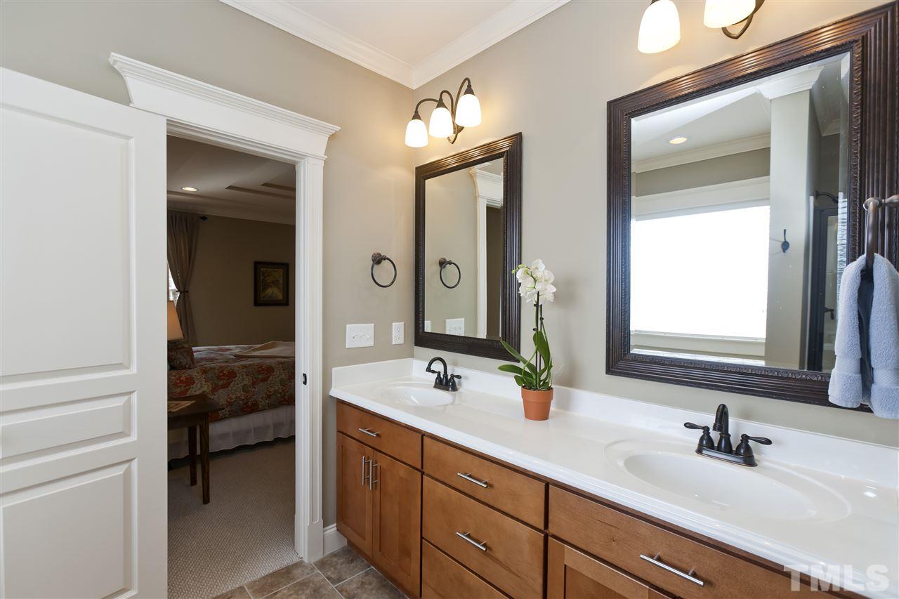 101 South Sunset Ridge Drive Willow Spring, NC 27592 - Photo 15 of 25 a bathroom with double vanity sinks and a mirror