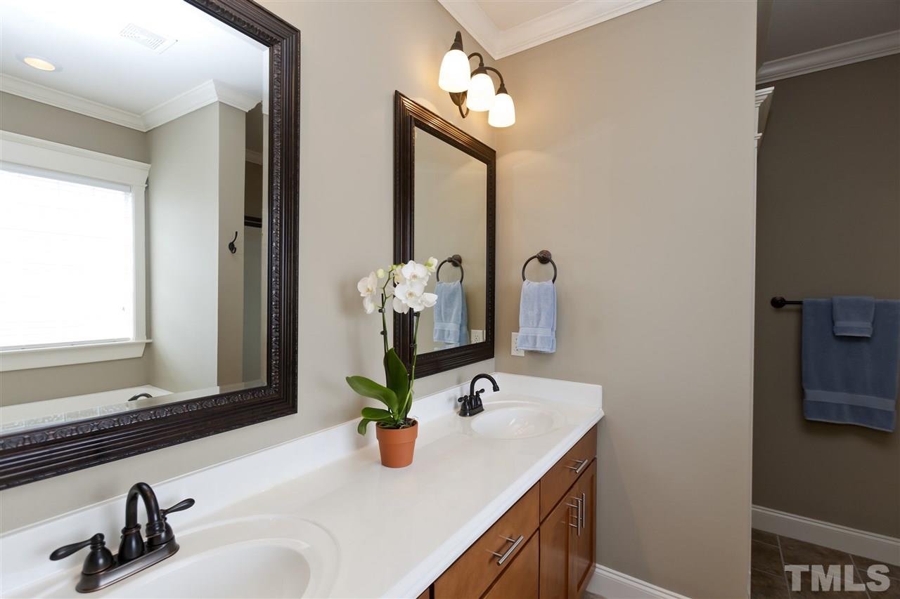 101 South Sunset Ridge Drive Willow Spring, NC 27592 - Photo 16 of 25 a bathroom with a sink and a mirror