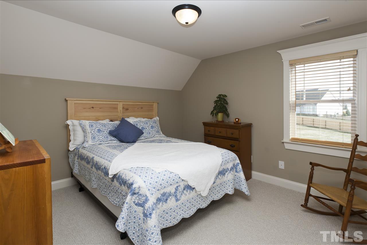 101 South Sunset Ridge Drive Willow Spring, NC 27592 - Photo 18 of 25 a bedroom with a bed and a window