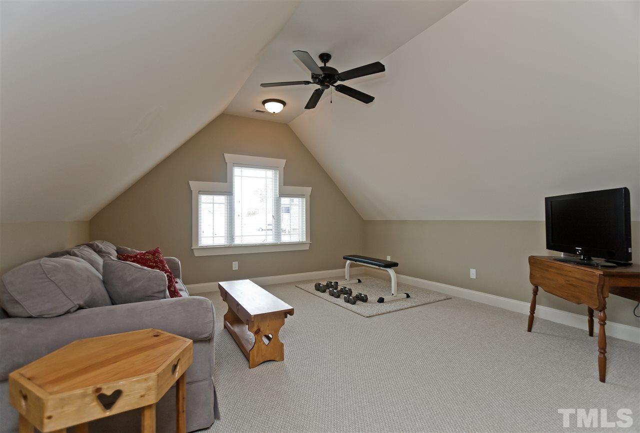 101 South Sunset Ridge Drive Willow Spring, NC 27592 - Photo 19 of 25 a living room with furniture and a flat screen tv