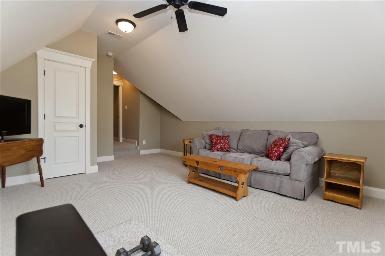 101 South Sunset Ridge Drive Willow Spring, NC 27592 - Photo 20 of 25 a living room with furniture and a flat screen tv