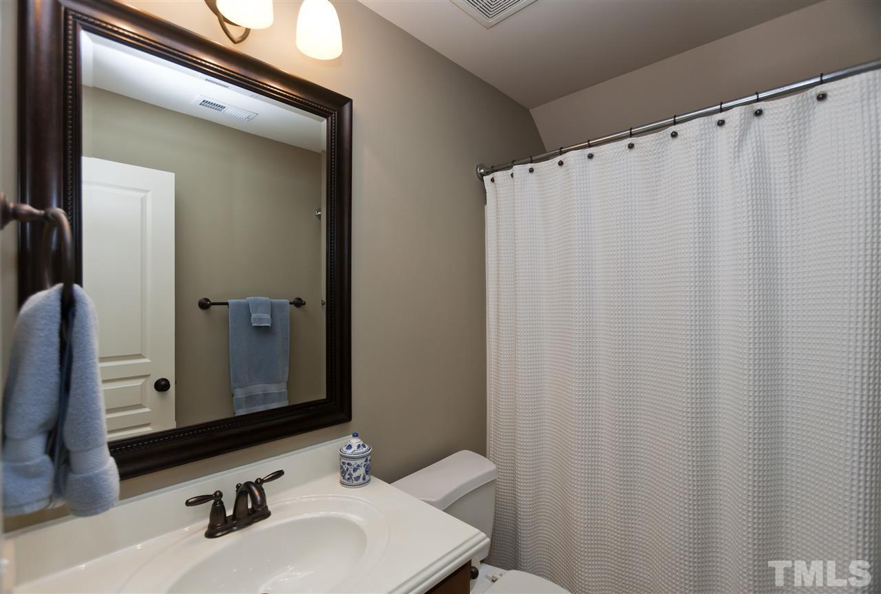 101 South Sunset Ridge Drive Willow Spring, NC 27592 - Photo 23 of 25 a bathroom with a sink and a mirror