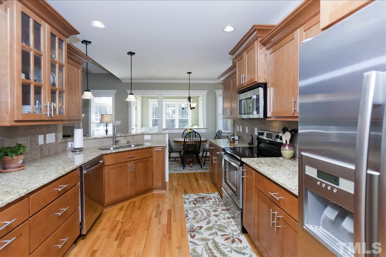 101 South Sunset Ridge Drive Willow Spring, NC 27592 - Photo 9 of 25 a kitchen with stainless steel appliances granite countertop sink stove and cabinets