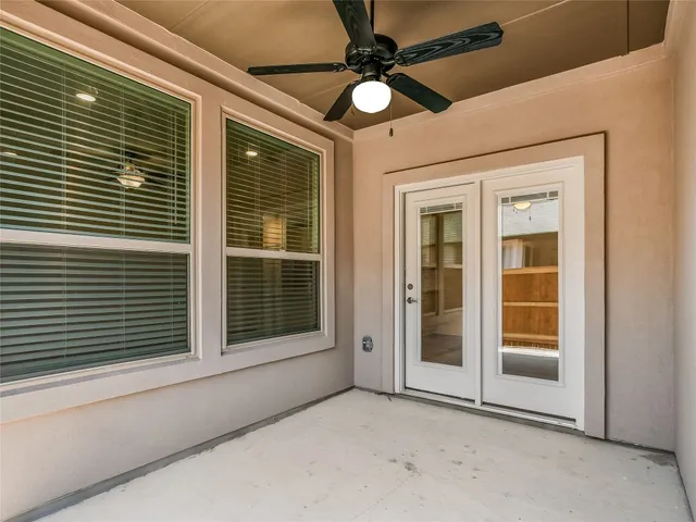 a view of a livingroom with a ceiling fan and window