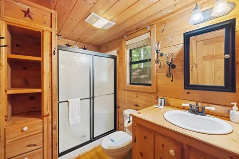 a bathroom with a sink toilet and shower