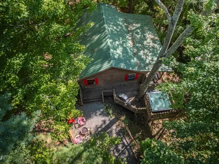 an aerial view of a house with a yard basket ball court and outdoor seating