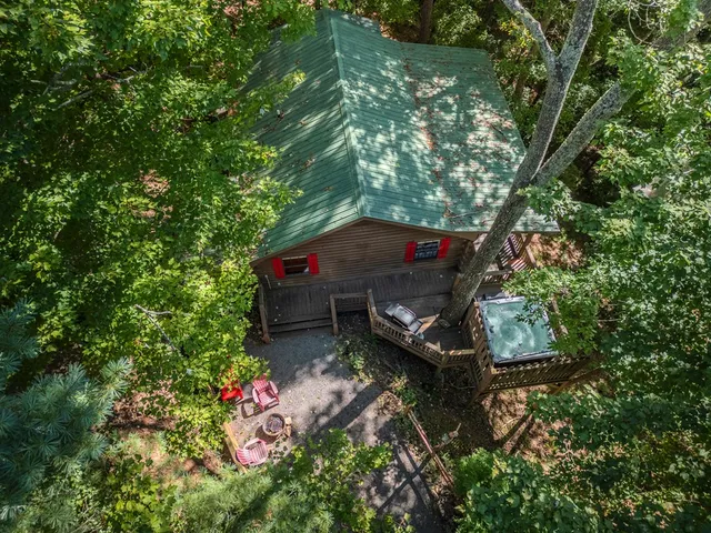 an aerial view of a house with a yard basket ball court and outdoor seating