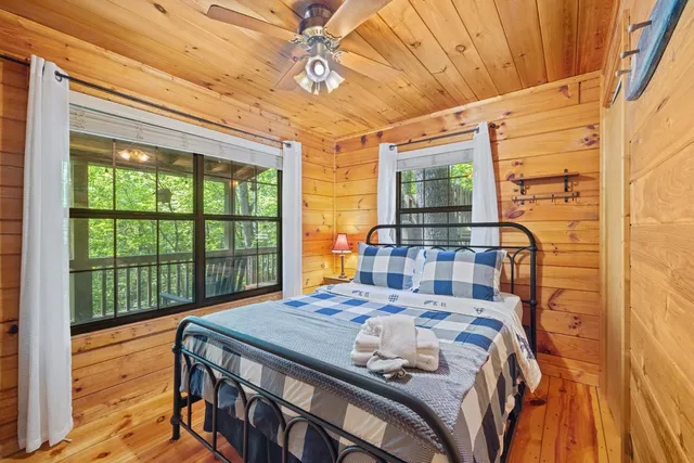 a bedroom with a bed and a large window