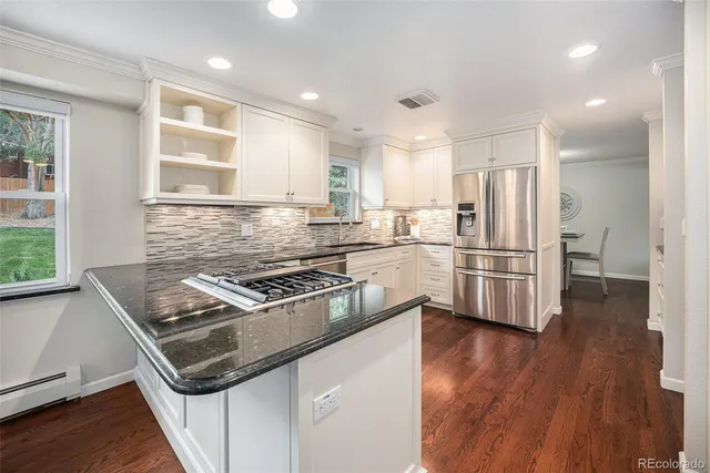 a kitchen with wooden cabinets and stainless steel appliances