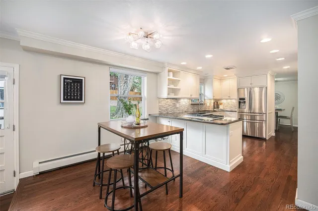 a kitchen with a table and chairs in it