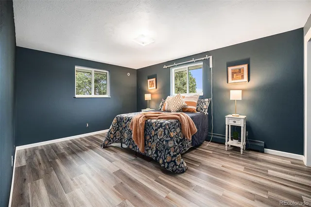 a bedroom with a bed lamp and a window