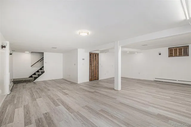 a view of an empty room with wooden floor