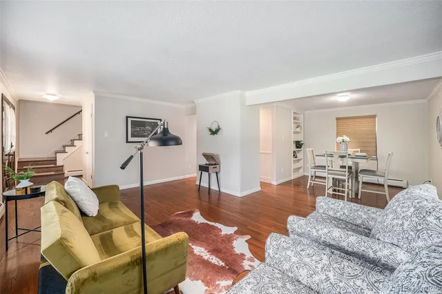 a living room with furniture wooden floor and a table