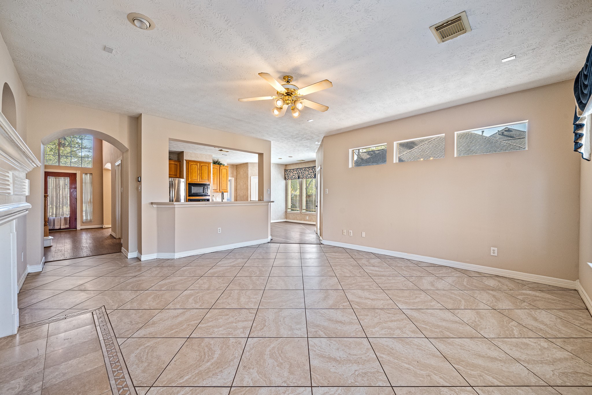 9306 Lochflora Drive Spring, TX 77379 - Photo 11 of 48 a view of an empty room with window and chandelier fan