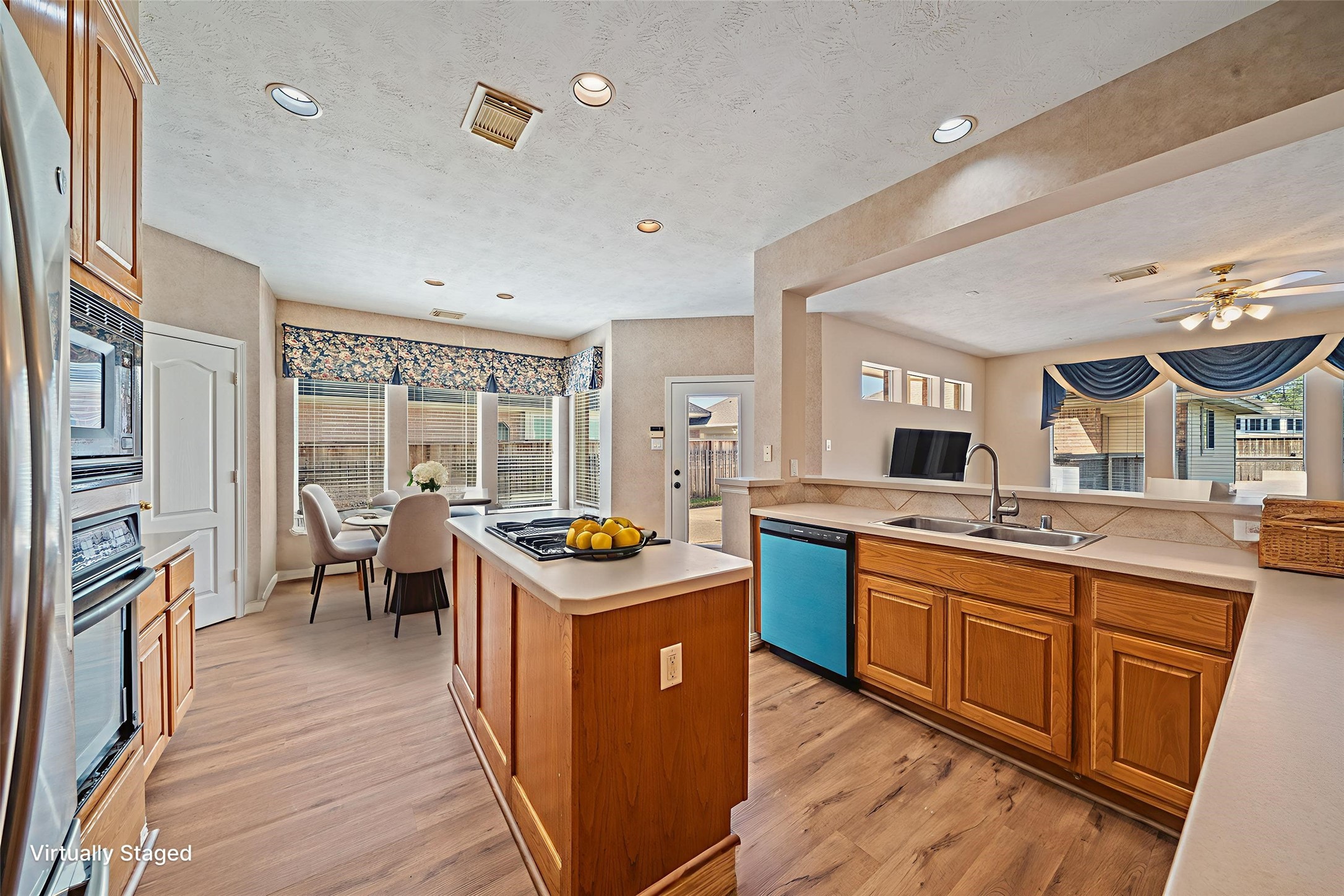 9306 Lochflora Drive Spring, TX 77379 - Photo 12 of 48 a kitchen with stainless steel appliances a stove top oven and a refrigerator