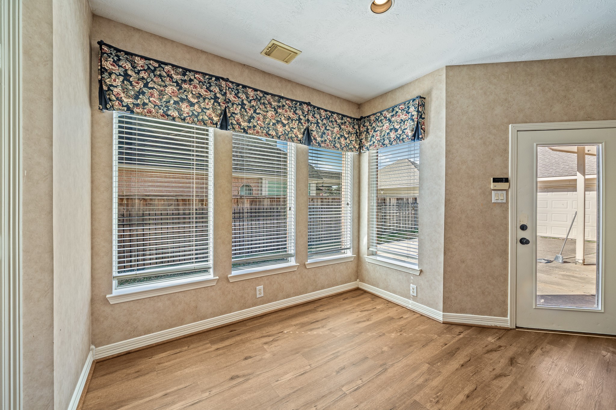 9306 Lochflora Drive Spring, TX 77379 - Photo 15 of 48 a view of an empty room with wooden floor and a window