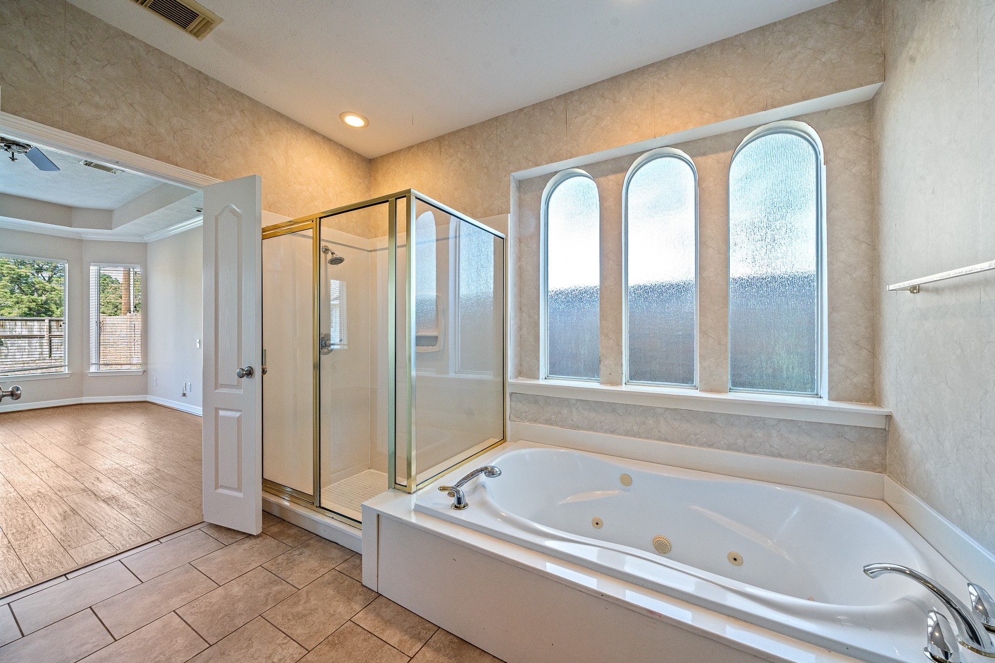 9306 Lochflora Drive Spring, TX 77379 - Photo 21 of 48 a bathroom with a tub a mirror and a shower