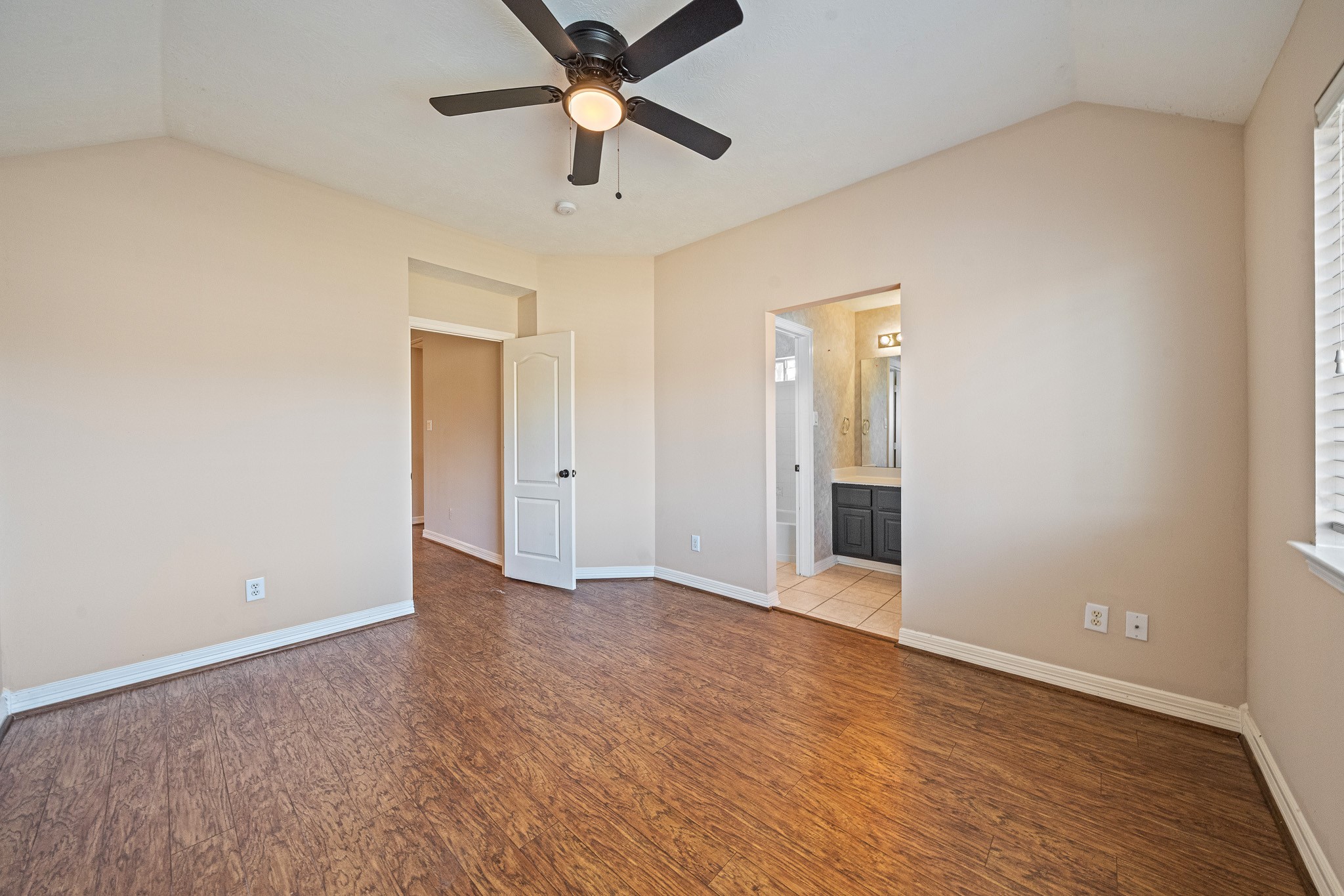 9306 Lochflora Drive Spring, TX 77379 - Photo 27 of 48 an empty room with wooden floor and a ceiling fan
