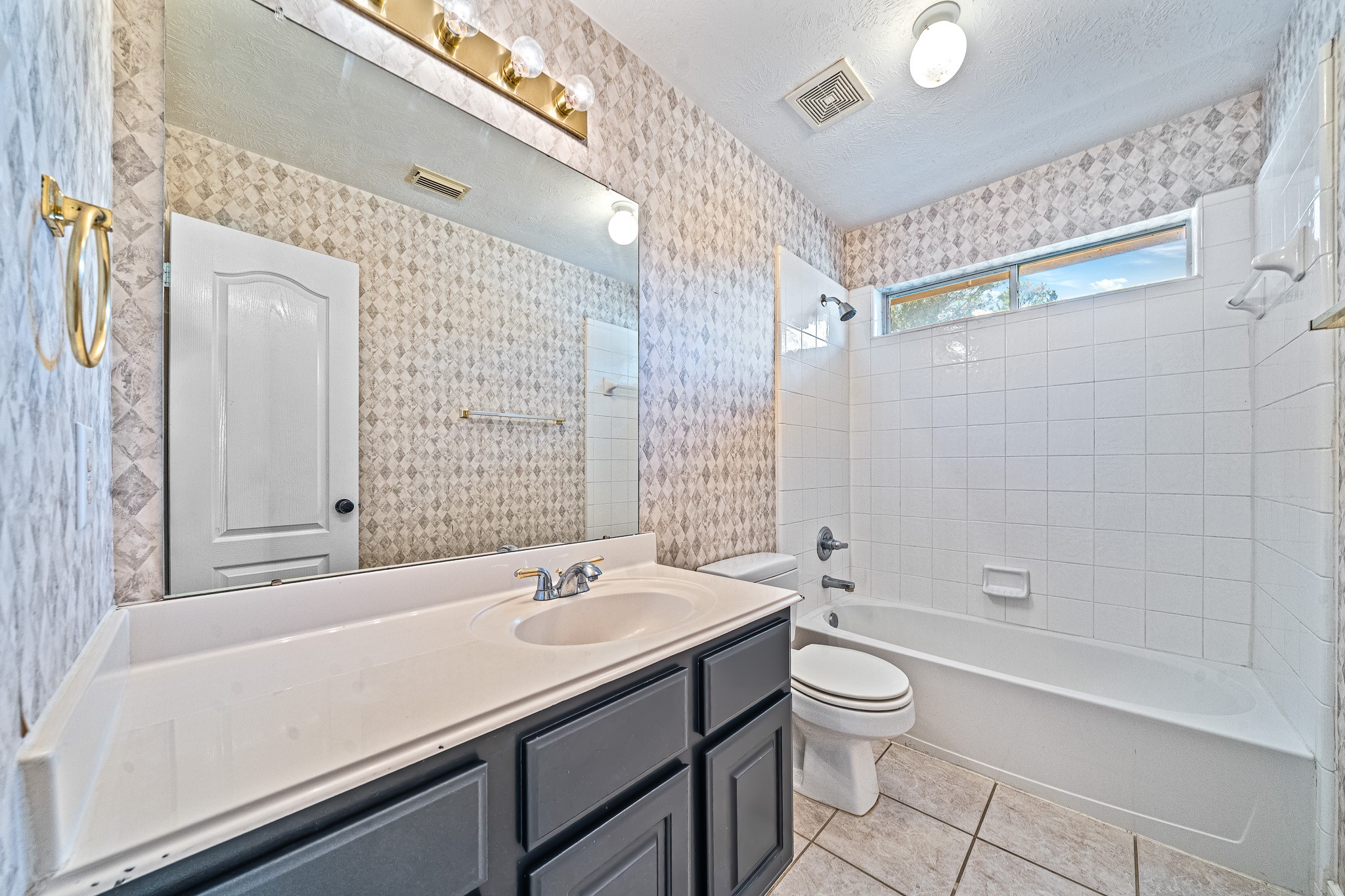 9306 Lochflora Drive Spring, TX 77379 - Photo 36 of 48 a bathroom with a granite countertop sink a toilet a mirror and shower
