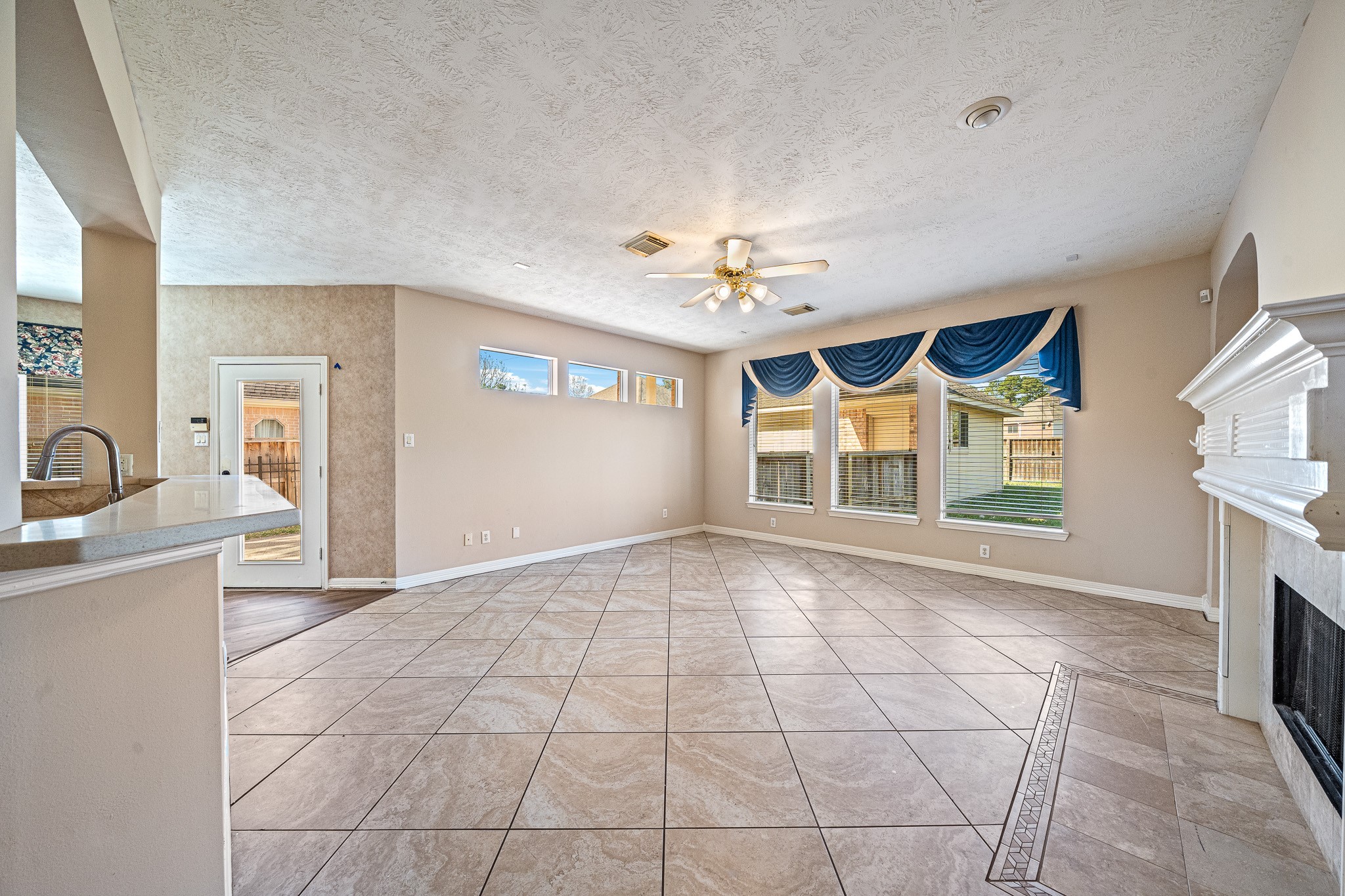 9306 Lochflora Drive Spring, TX 77379 - Photo 10 of 48 a view of an empty room with a fireplace and a window