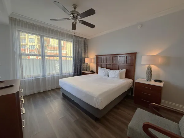a bedroom with a bed and a large window