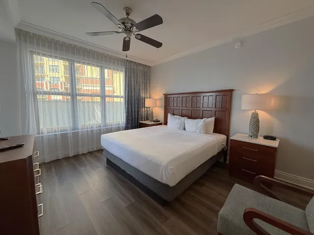 a bedroom with a bed and a large window