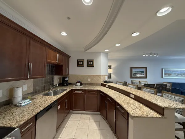 a kitchen with granite countertop a sink and a stove