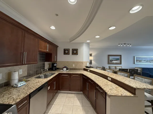 a kitchen with granite countertop a sink and a stove