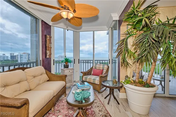 a living room with furniture a lamp and a potted plant