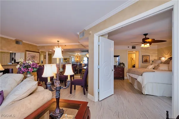 a living room with furniture and a dining table with wooden floor