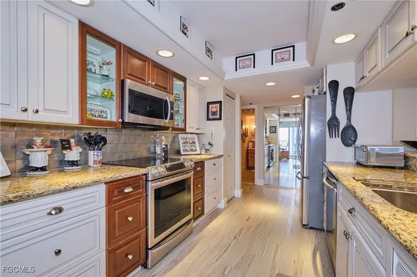 a kitchen with a stove a sink and a microwave