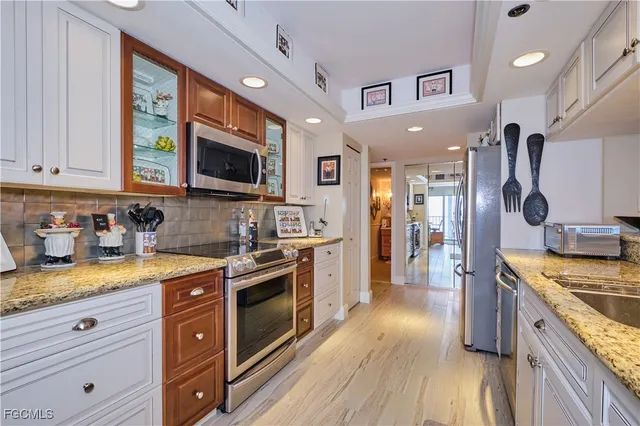 a kitchen with a stove a sink and a microwave