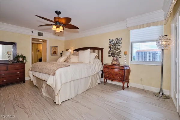 a bedroom with a bed and a chandelier