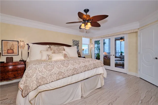 a bedroom with a large bed and a chandelier